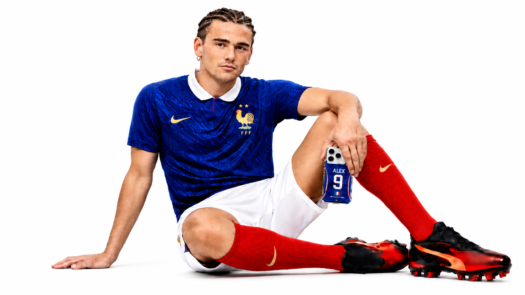 Football player in a France jersey holding a blue, white, and red personalized TheCaze phone case.